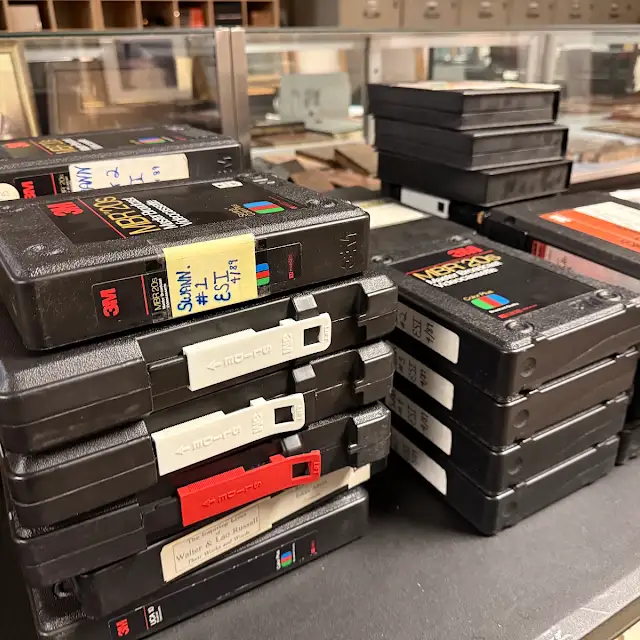 Stacks of labeled 3M U-matic videocassettes from a production archive.